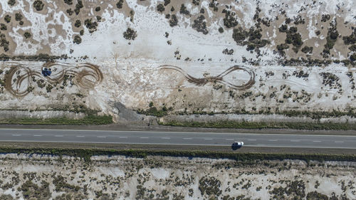 Aerial view of road amidst field