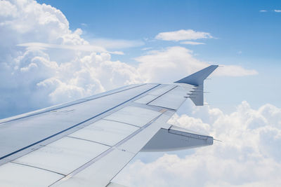 Cropped image of airplane against blue sky