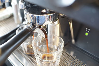 Close-up of coffee pouring in glass