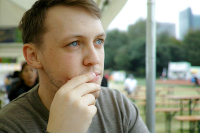 Thoughtful man looking away outdoors