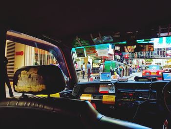 Rear view of man seen through car windshield at night