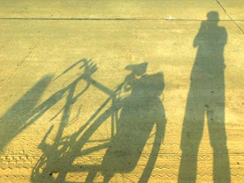 High angle view of shadow of man on ground