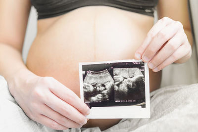 Midsection of woman holding hands