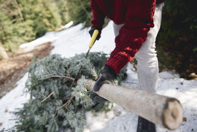 Midsection of man working on street during winter