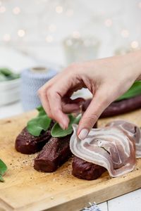 Close-up of man preparing food on cutting board