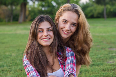 Portrait of smiling young woman on field