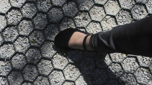 Low section of person standing on stone street