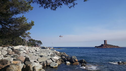 Scenic view of sea against clear blue sky