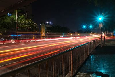 Light trails on road in city at night