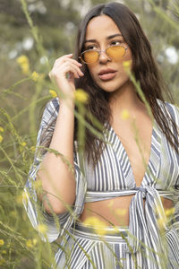 Stylish latina woman with sunglasses in flower fields