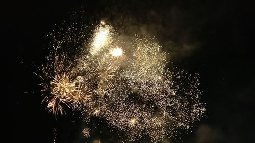 Low angle view of firework display against sky at night