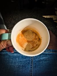 Low section of woman holding coffee cup