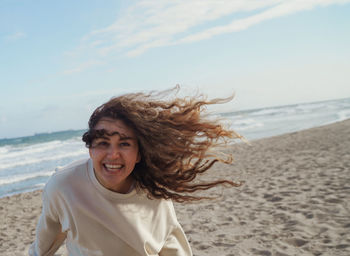 Portrait of smiling young woman on beach