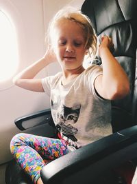 Full length of girl sitting in car