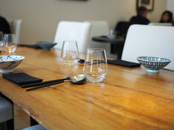 Wine glasses and ceramic bowls on table in restaurant