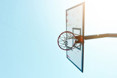 Low angle view of basketball hoop against clear sky