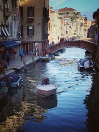 Boats in canal with buildings in background