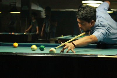 Young man playing snooker