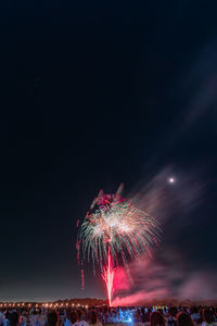 Low angle view of firework display at night