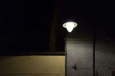 Low angle view of lamp post at night