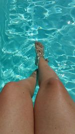 Low section of woman in swimming pool