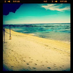 Scenic view of beach against blue sky