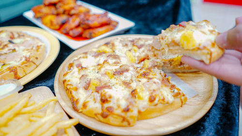 Close-up of hand holding food in plate