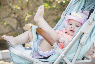 Portrait of cute girl sitting on slide