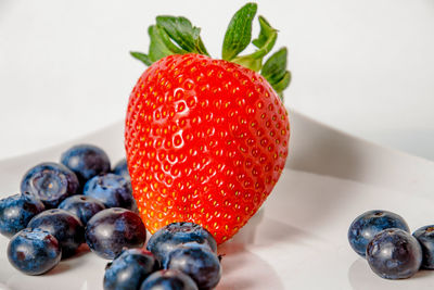 Close-up of cherries on apple