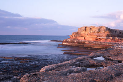 Scenic view of sea against cloudy sky