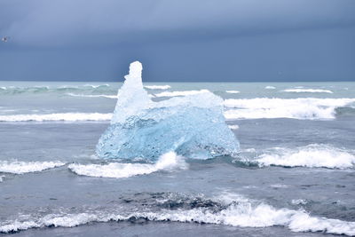 Scenic view of sea waves against sky