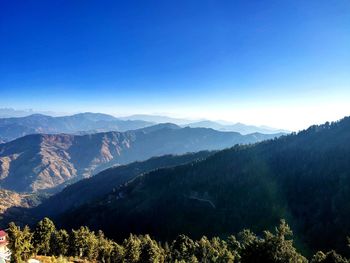 Scenic view of mountains against clear blue sky