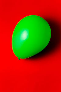 Close-up of multi colored balloons against red background