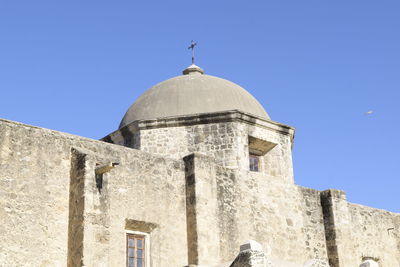 Low angle view of old building against clear blue sky