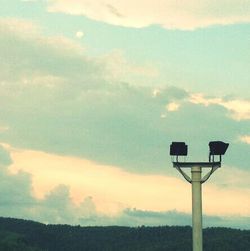 Low angle view of landscape against cloudy sky