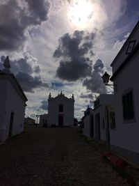 Buildings against cloudy sky