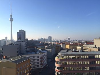 Fernsehturm in city against clear blue sky