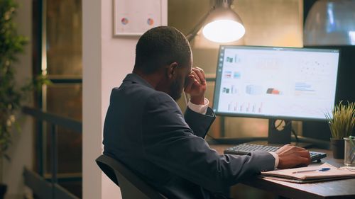 Side view of man working at office