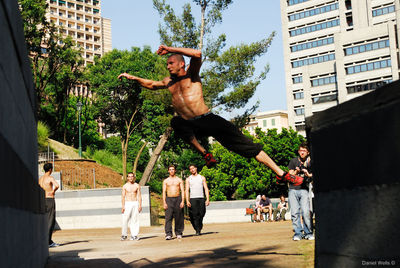 Men jumping in city