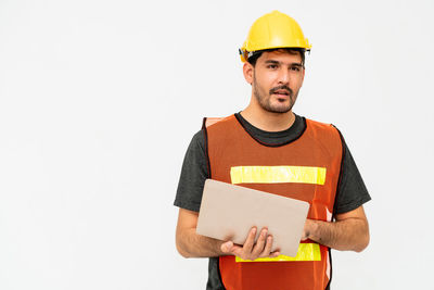 Portrait of smiling man standing against white background