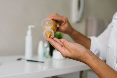 Woman applies a cosmetic moisturizer for skin care