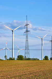 An electricity pylon and wind energy generators seen in germany