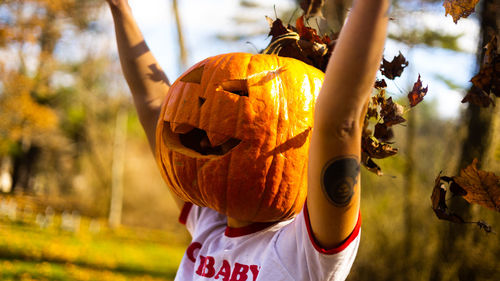 Rear view of woman holding lantern