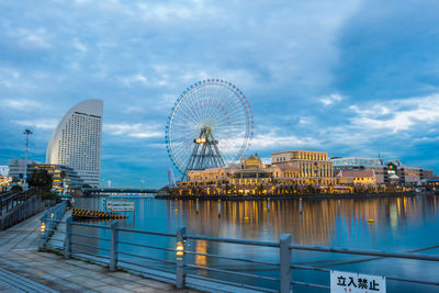 Ferris wheel in city against sky