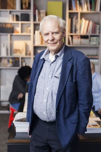 Portrait of senior businessman standing in office