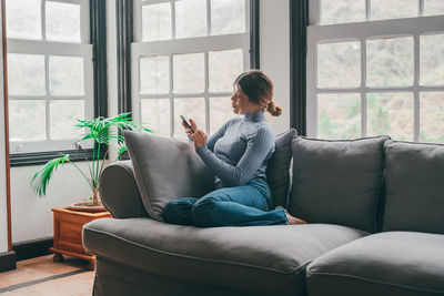 Young woman using laptop at home