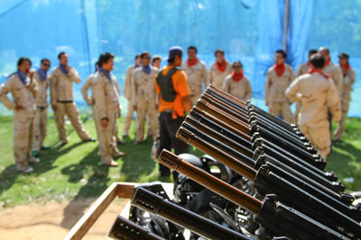 View of guns with people on field in background