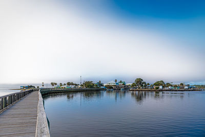 Pier over lake against sky