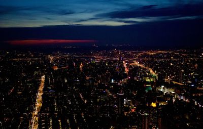 High angle view of city lit up at night