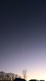 Low angle view of moon against clear sky at night